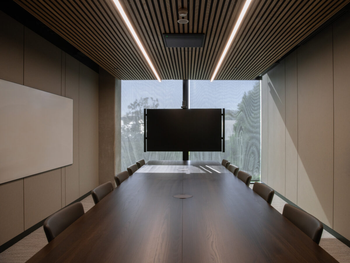 Boardroom with a dark timber table, timber slat ceiling, and floor-to-ceiling windows