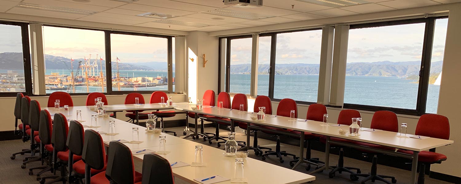 Conference room with u-shaped table layout and harbour views