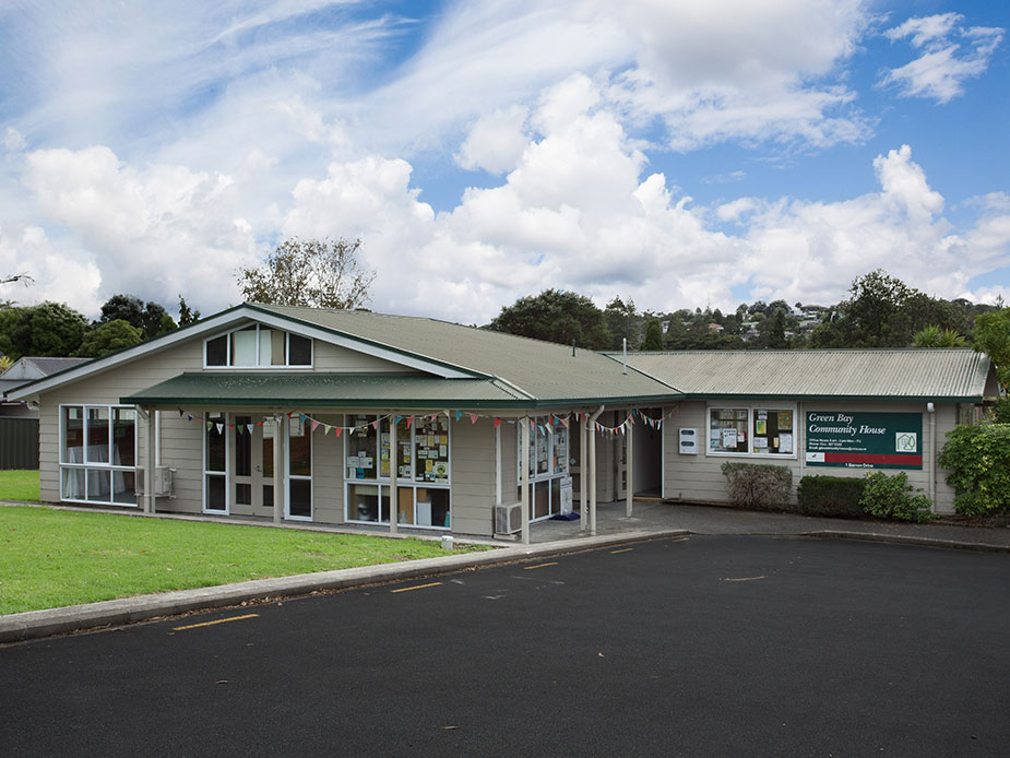 Single-storey community house building with covered entry and signage