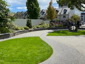 Landscaped garden approach with lawn, stone edging, and curved path