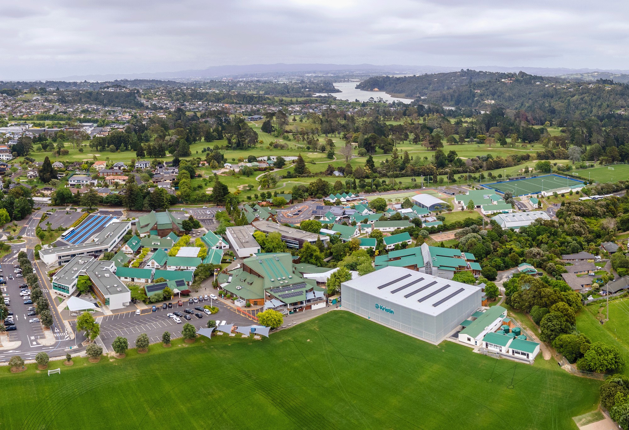 Aerial view of large school campus with sports fields and buildings