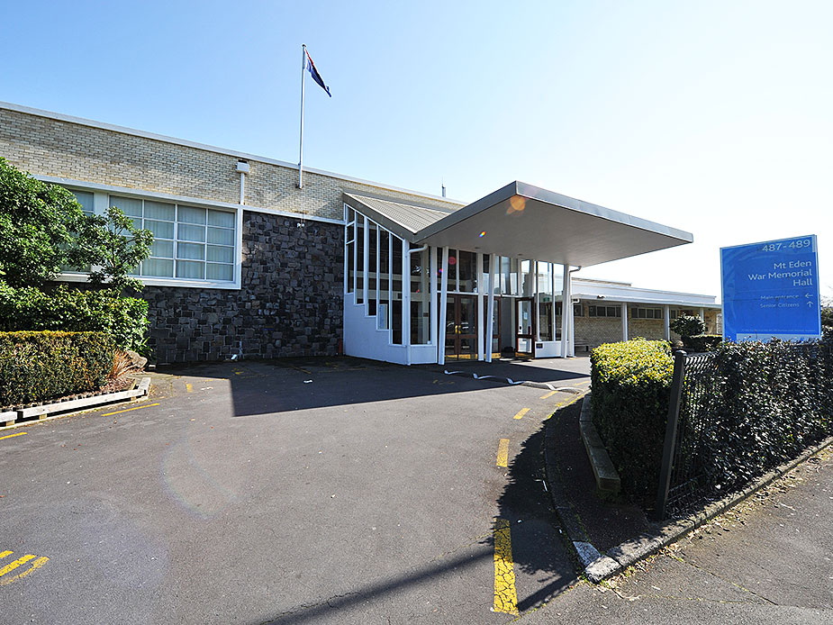 Mid-century civic hall exterior with canopy entrance and signage