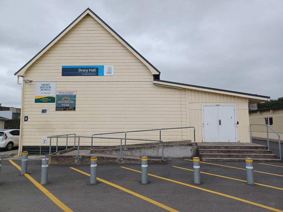 Hall front entrance with access ramp, steps and signage