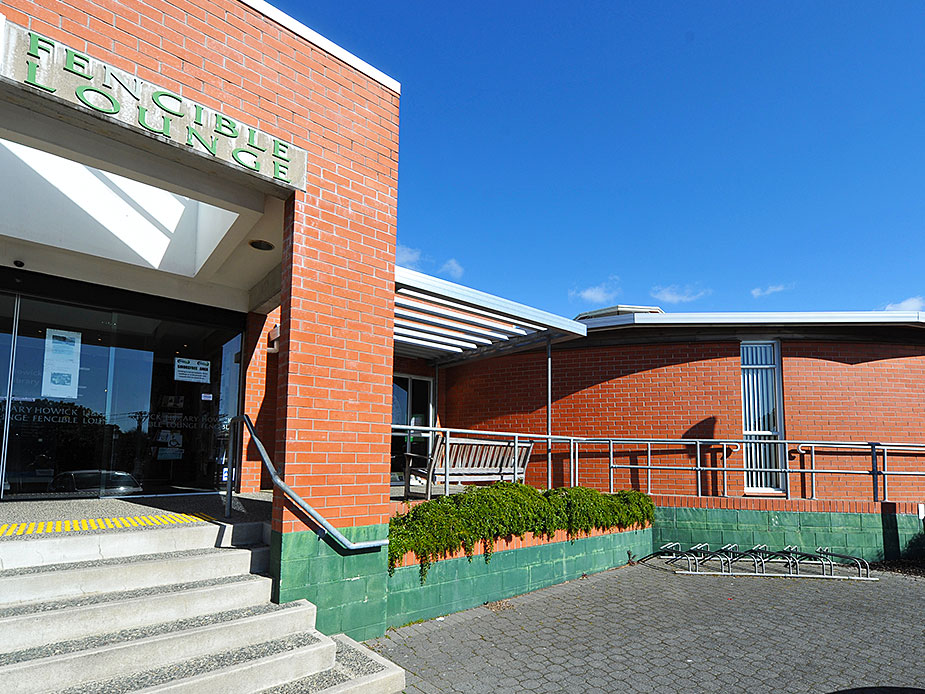 Brick library building with Fencible Lounge signage and steps at entrance