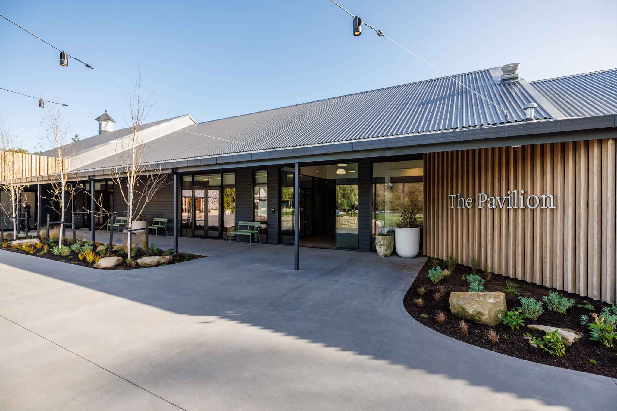 The Pavilion building entrance with corrugated roof and timber slat cladding
