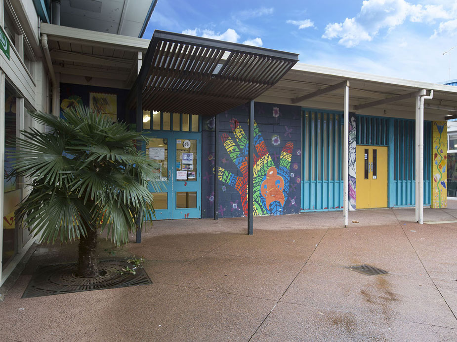 Low-rise building with colourful murals on exterior walls