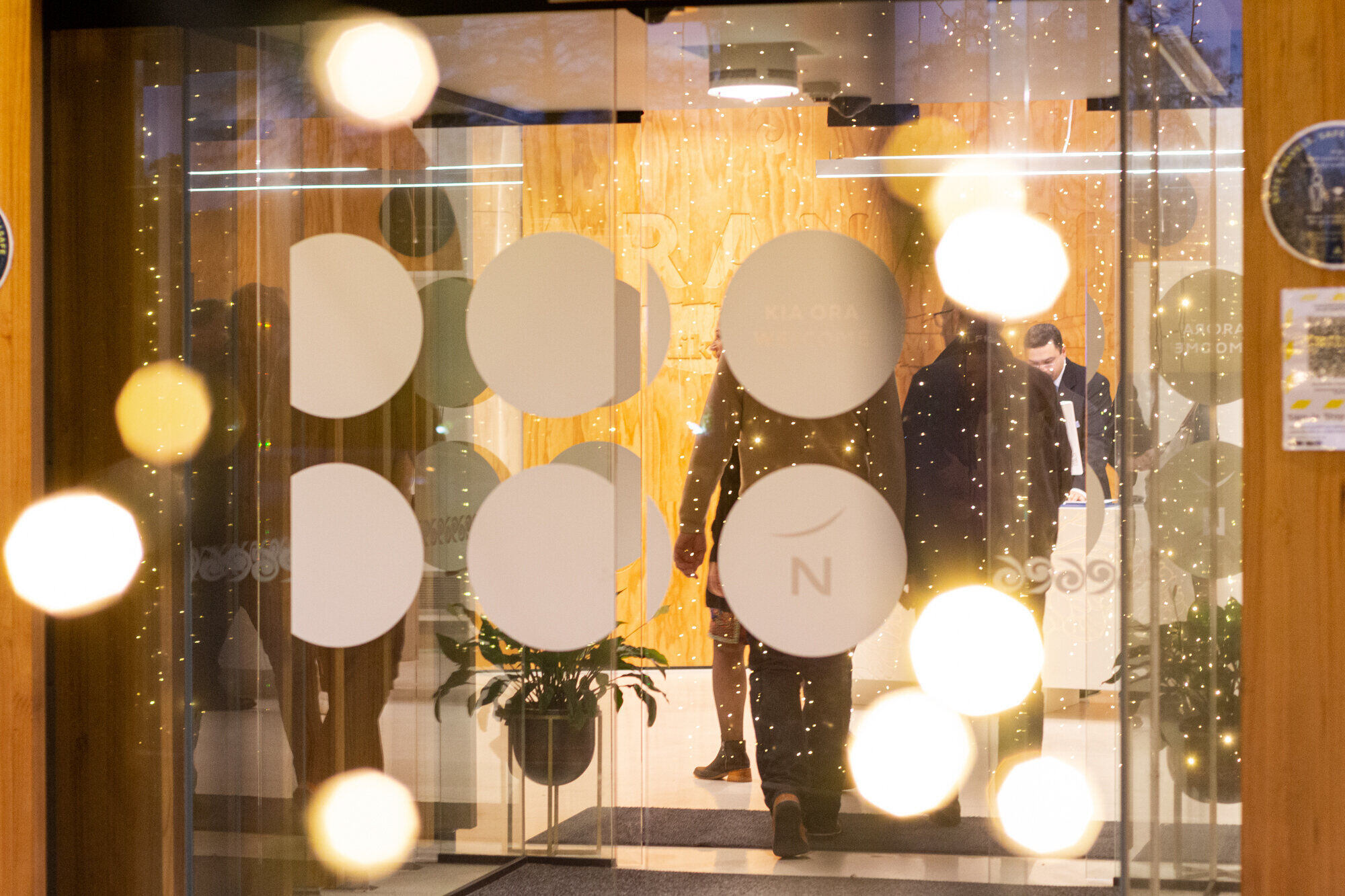 Hotel entrance lobby viewed through glass doors with decorative dot pattern