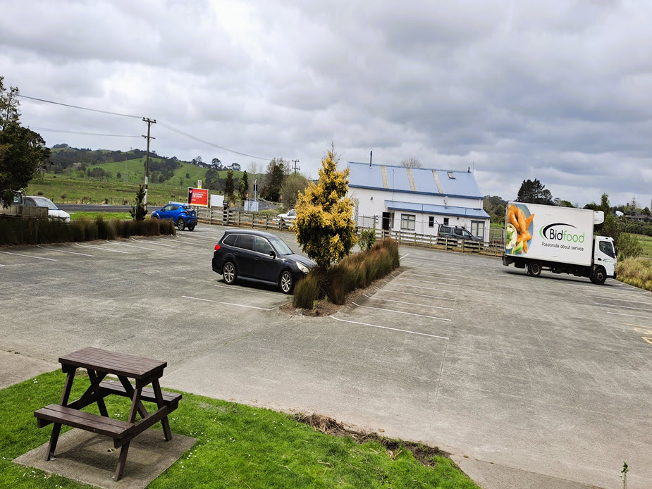Hall car park with delivery truck and rural surroundings