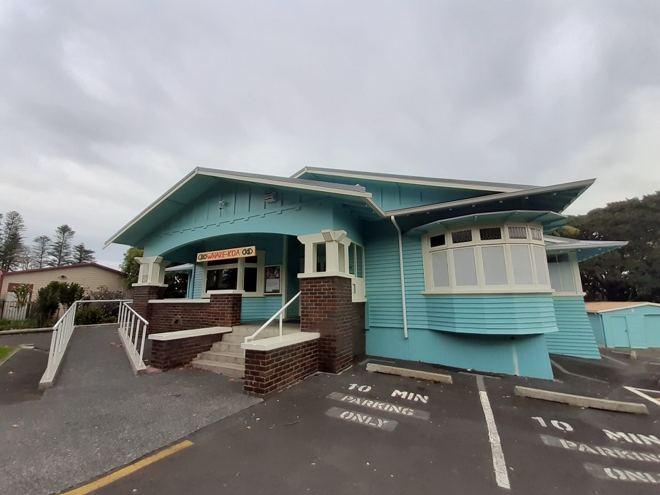 Painted weatherboard bungalow in teal with verandah and car park